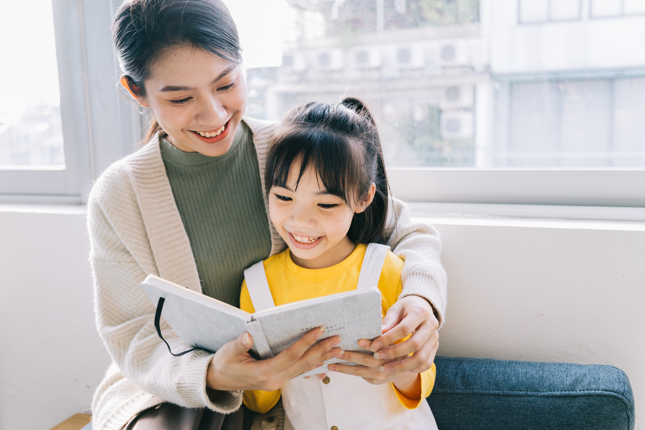 Mother and daughter reading a Korean children's book together.
