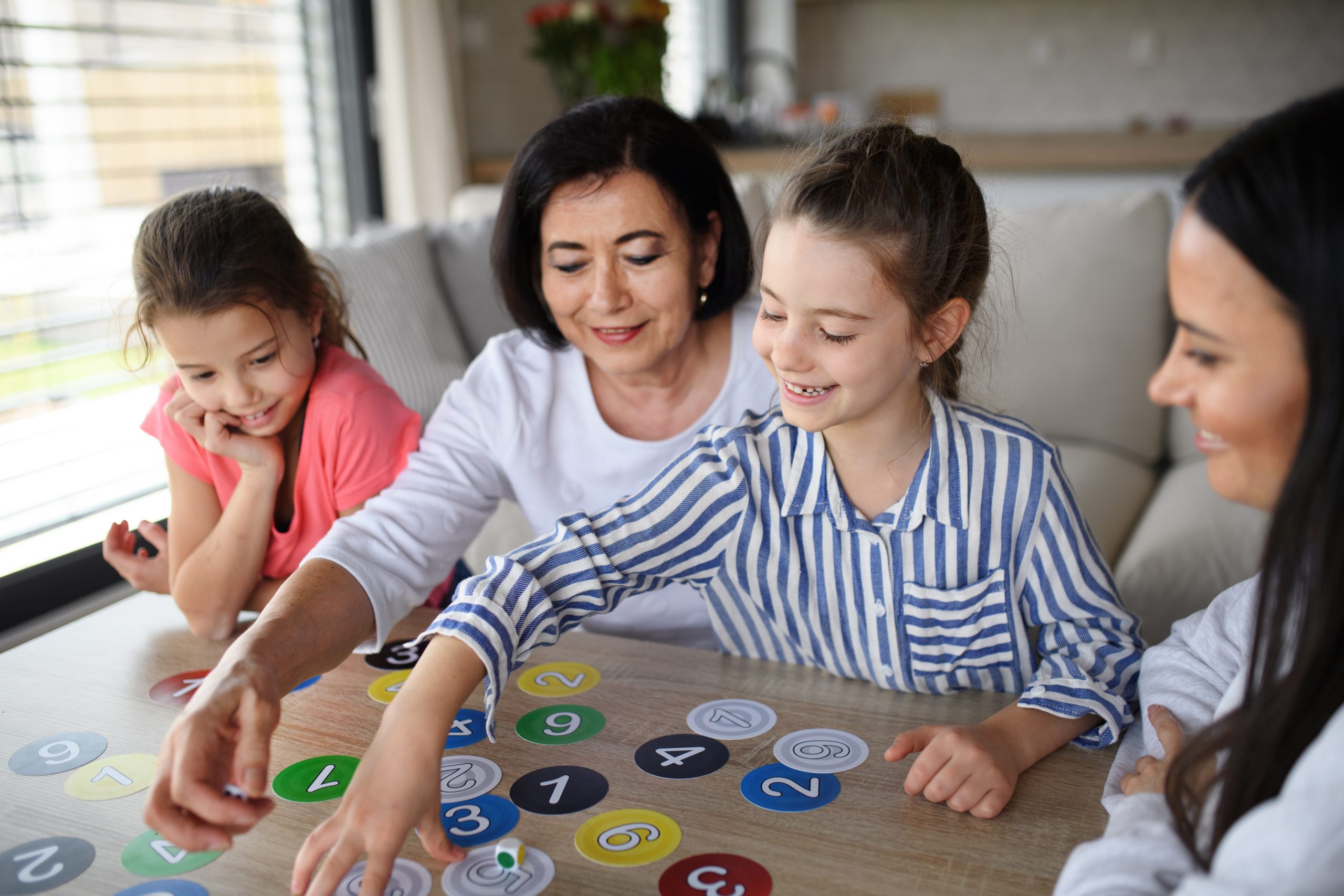 Family playing games to improve English for kids.